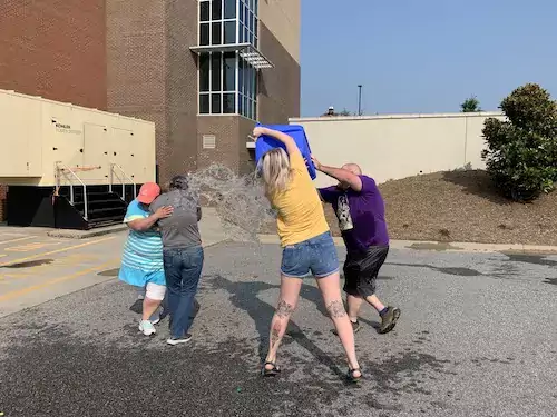 Two people dumping water on vice president Stewart