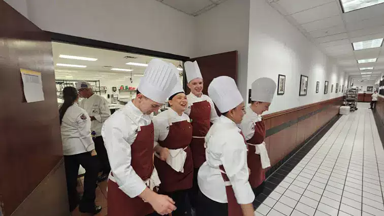 The A-B Tech 2024 competitive cooking team leaving a round of challenges.