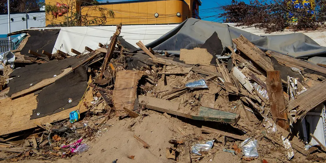 Silver bags of tea bags are seen among the rubble of the Asheville Tea Company production facility, October 31, 2024, which flowed nearly a mile down the Swannanoa River to the parking lot of Asaka Japanese Cuisine.