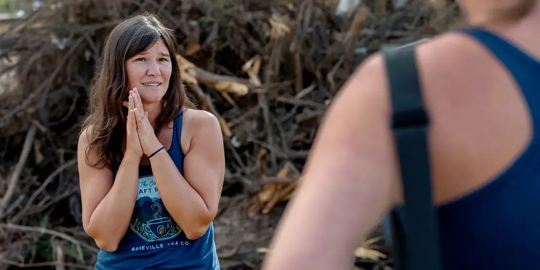 Jessie Dean, founder of Asheville Tea Company, talks to her sister, Melissa, director of sales at the site of their production facility along the Swannanoa River in Asheville after the destruction of Tropical Storm Helene, October 31, 2024.