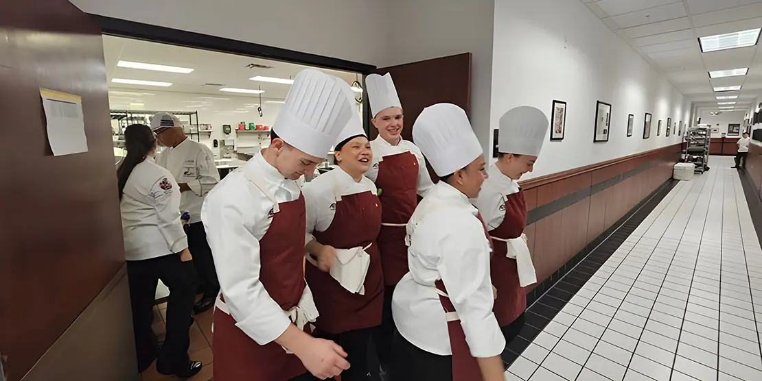 The A-B Tech 2024 competitive cooking team leaving a round of challenges.