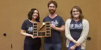 Ashley Gillett, Vincent Gendusa and Amy Taylor holding quiz bowl award