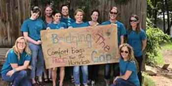 Group of OTA students with banner