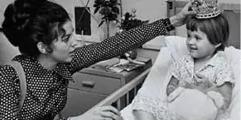 Connie Learner, the first Jewish Miss North Carolina in 1970, places a tiara on a young girl's head.