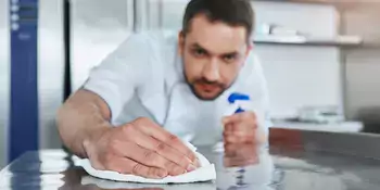 Man cleaning counter top