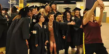 Students taking group selfie at commencement