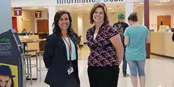 Jenna Deal and Heather Pack standing in the lobby of the Bailey Building.