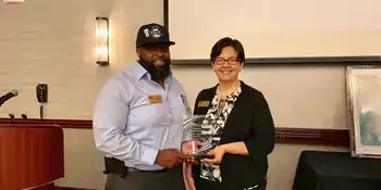 Philip Cooper and Shelley White holding CCA Award