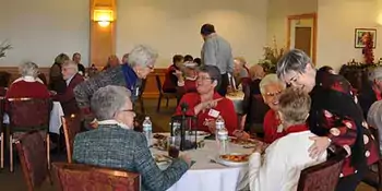 Men and women in a dining room eating brunch.