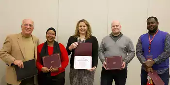 Five people holding RISE awards