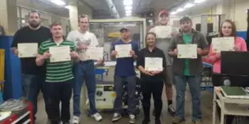 Eight students holding certificates.