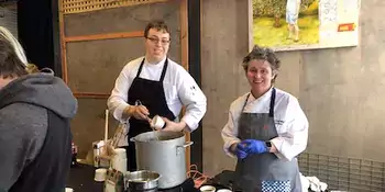 Two chefs behind a table