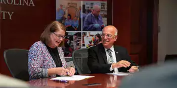 Kelli Brown and Dennis King signing WCU admission agreement