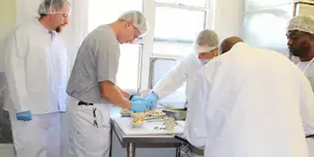 Four men working in a kitchen