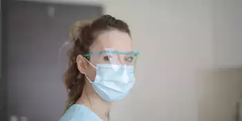 Woman wearing a mask and safety glasses