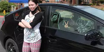 Gabriella Kusz stands next to her mother's car