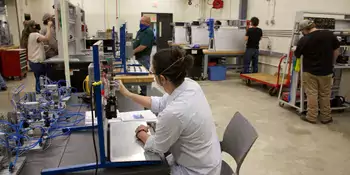 Person working at a station in a laboratory