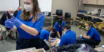 EMS students working on mannequin in the classroom.