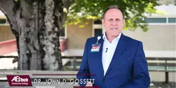 John Gossett standing on a deck in front of a tree