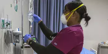 Nursing student checking IV bags