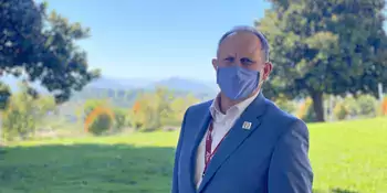 Dr. John Gossett standing outside wearing a blue face mask