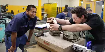 Two men working on a machine