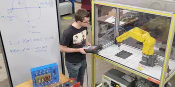 Students using robot arm