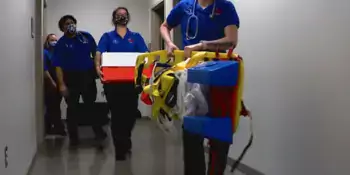 EMS students with equipment in a hallway