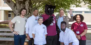 Dr. Gossett poses with a group of students