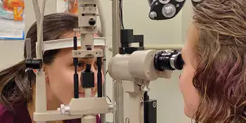 An ophthalmic student checking a patient