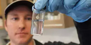 Man with vial of water