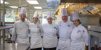 Five chefs in a kitchen