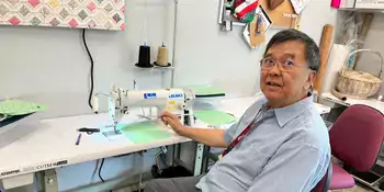 Job Preparedness: Johnny Ko teaches industrial sewing classes at the A-B Tech satellite campus at Asheville Buncombe Community Christian Ministry. Ko demonstrates how to use a single needle Juki industrial sewing machine in a classroom. Photo by Jessica Wakeman