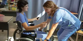 2 Nursing Students working with wheelchair