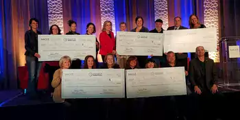 Winners posing with checks.