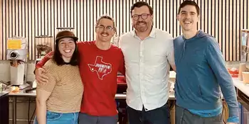 Employees smiling at cafe.