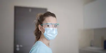 Woman wearing a mask and safety glasses