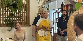 Woman in yellow apron in restaurant