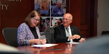 Kelli Brown and Dennis King signing WCU admission agreement
