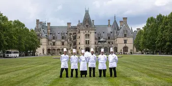 six chefs standing on a lawn in front of the Biltmore House
