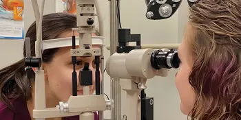An ophthalmic student checking a patient