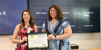 Elizabeth Bizer (left) awards A-B Tech Facilities Director Elizabeth Green with Energy Award 