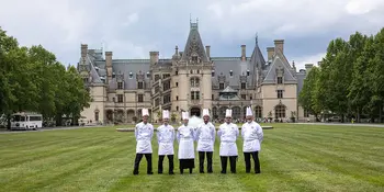 six chefs standing on a lawn in front of the Biltmore House