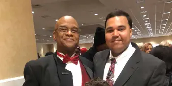 Joe Fox and Brandon Priester standing in auditorium