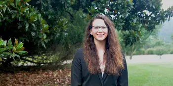 Woman standing next to a tree