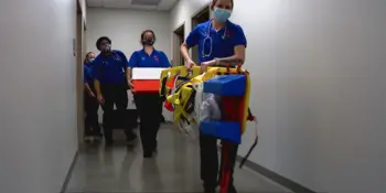 EMS students with equipment in a hallway