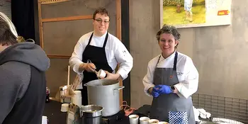 Two chefs behind a table