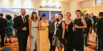 Five chefs with formal wear with coaches.