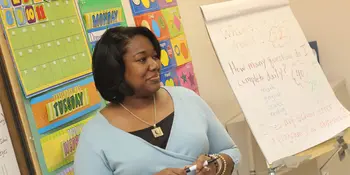 Woman teaching at board