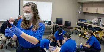 EMS students working on mannequin in the classroom.